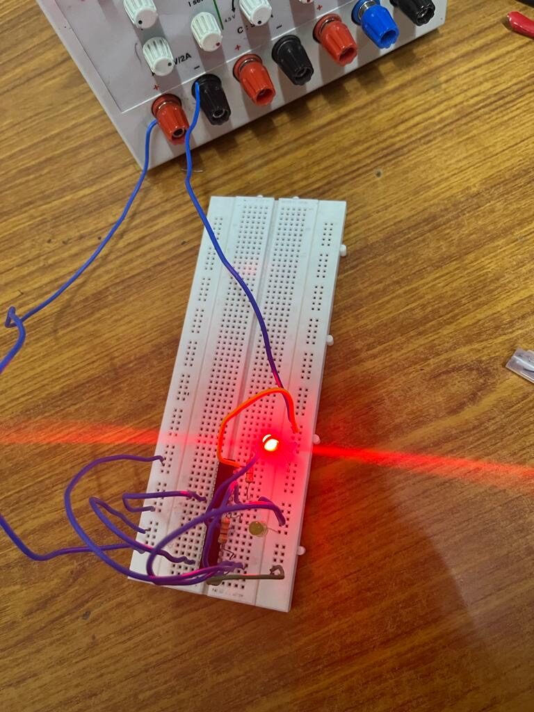 First breadboard circuit with glowing red LED